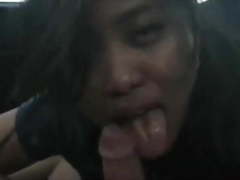 Asian girl sucks dick and swallows cum in a parked car